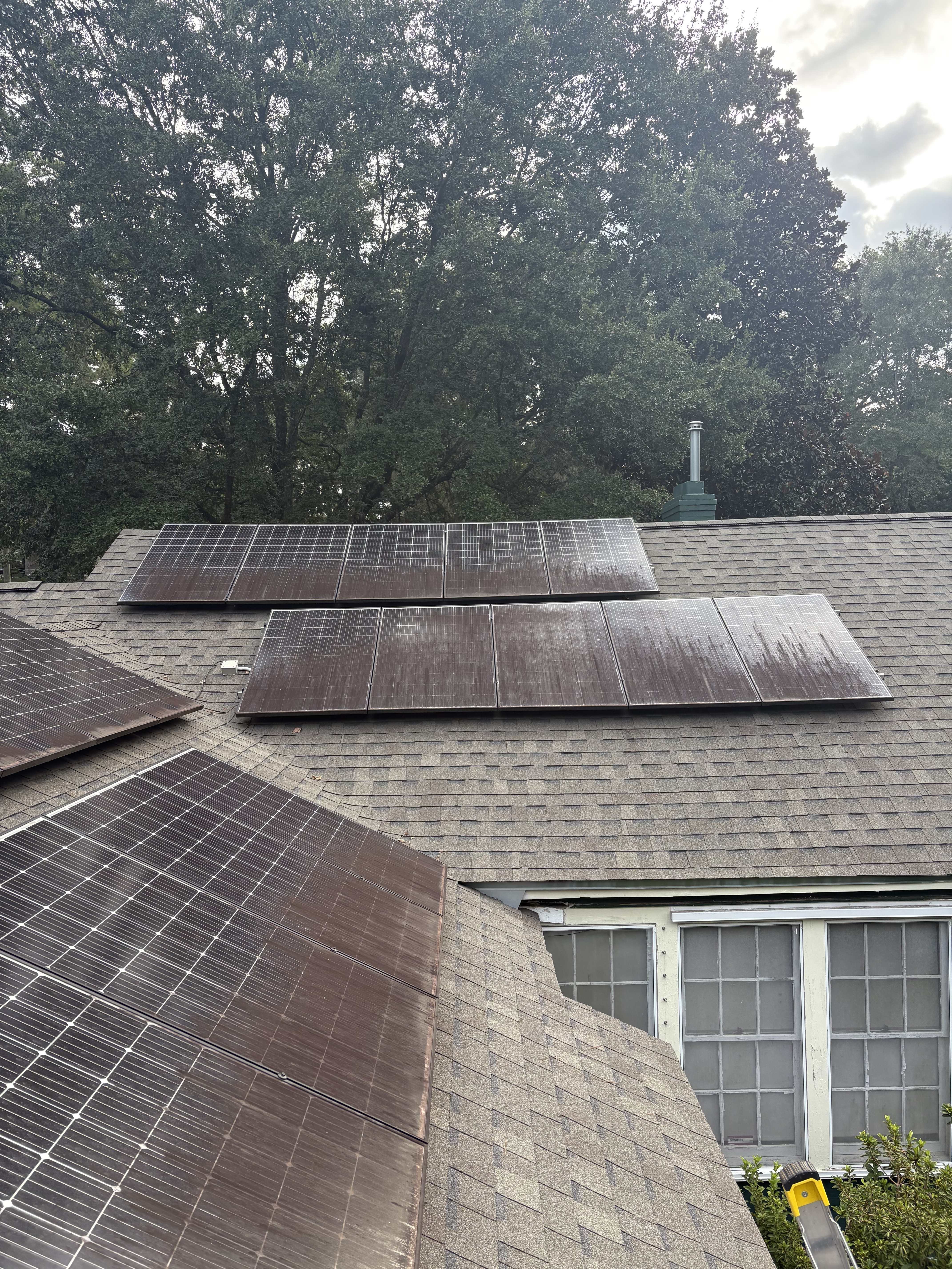 Dirty solar panels on residential roof showing dust and debris buildup that reduces efficiency