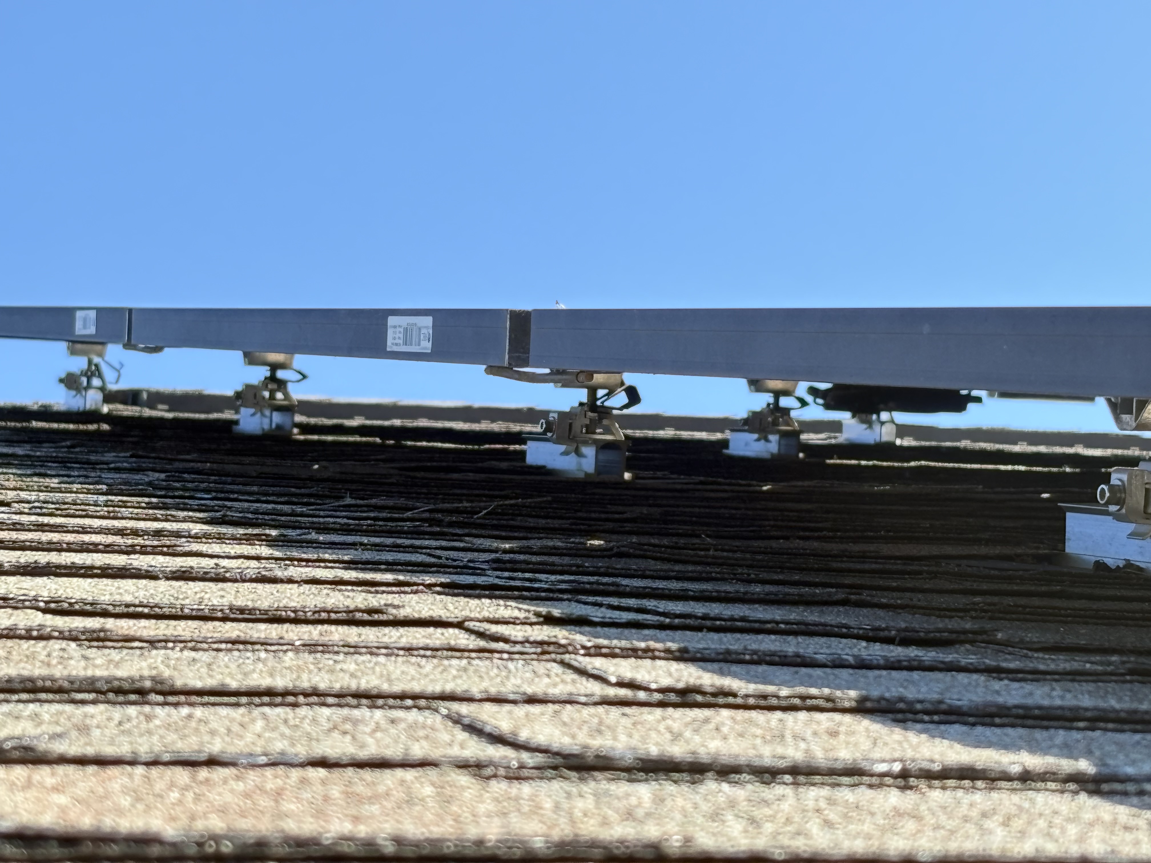 Solar panel installation showing professional mounting hardware